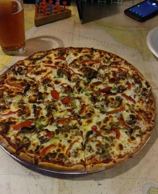 Pizza and craft beer on pirate map table